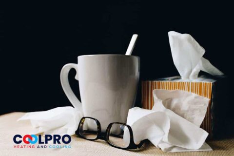 A cup of coffee with a tissue next to it.