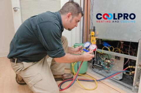 A man is working on an air conditioning unit.