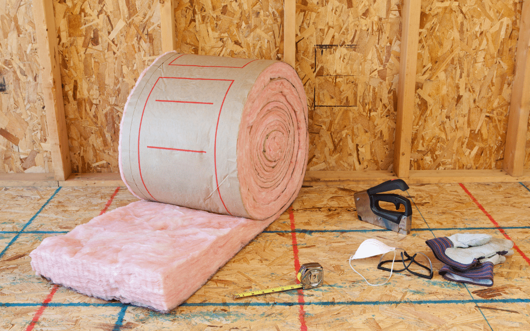 A roll of insulation is laid out on a wooden floor.