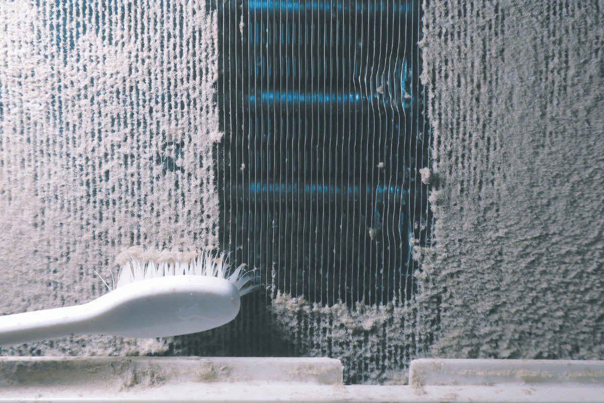 A toothbrush is being used to clean a wall.