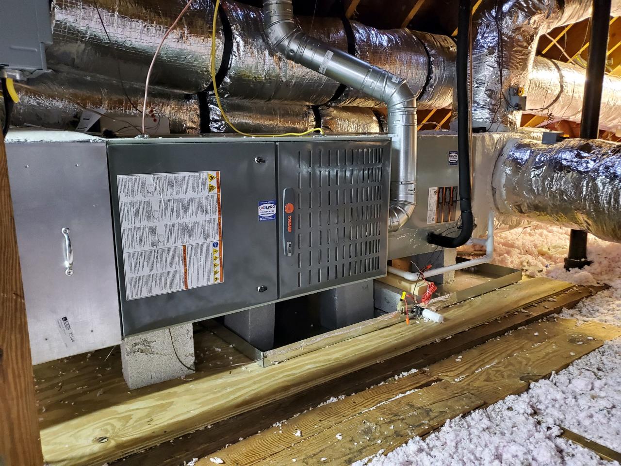 An air conditioner is being installed in an Atlanta house by Coolpro Heating and Cooling.