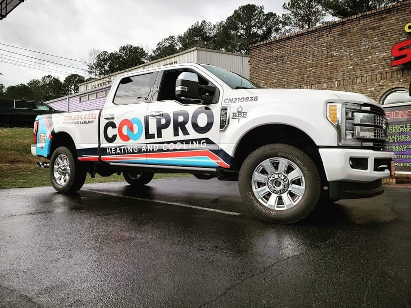 A ford super duty truck is parked in front of a business, providing information about its presence.