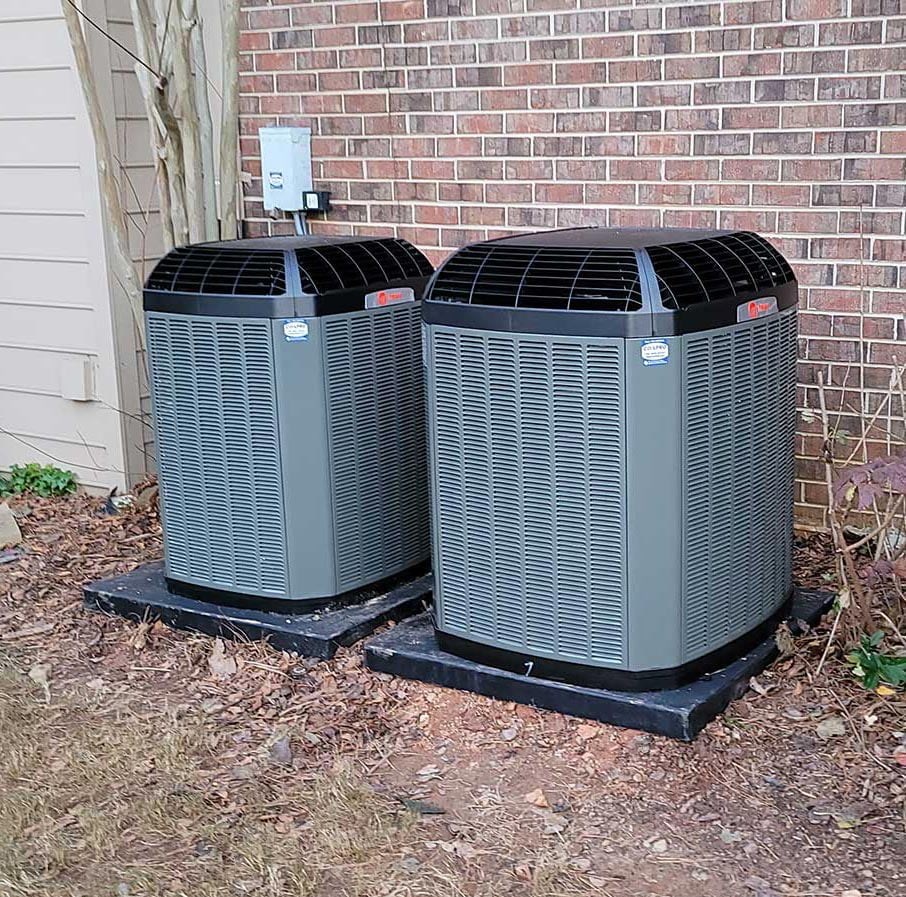 AC repair services are provided for two units on ac maintenance plans located behind a building.