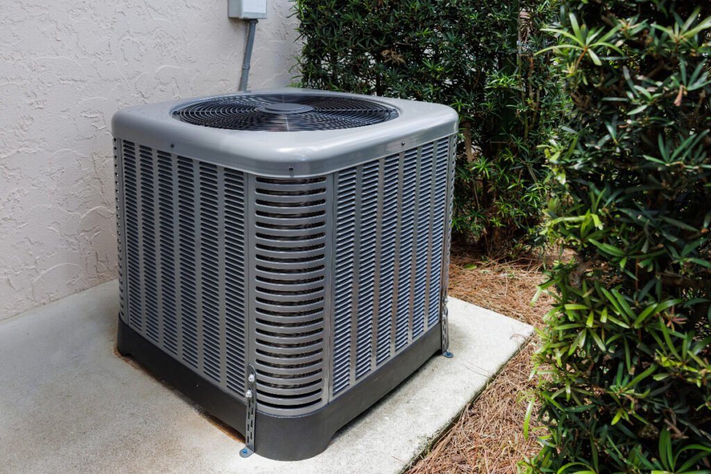 An air conditioner in front of a house.