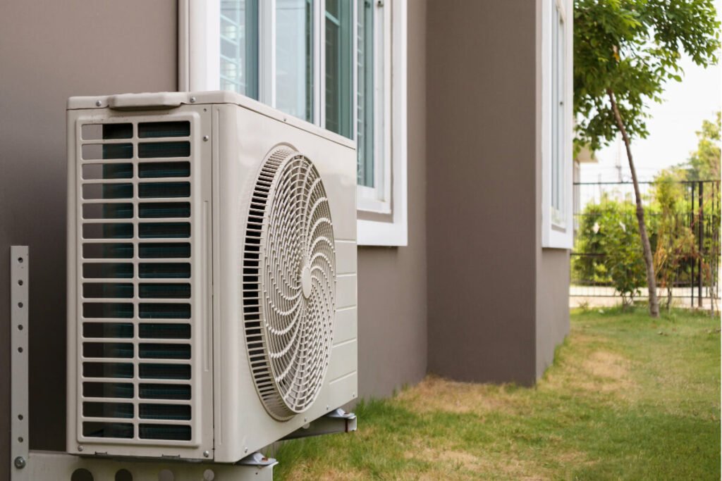 An air conditioner on the side of a house.