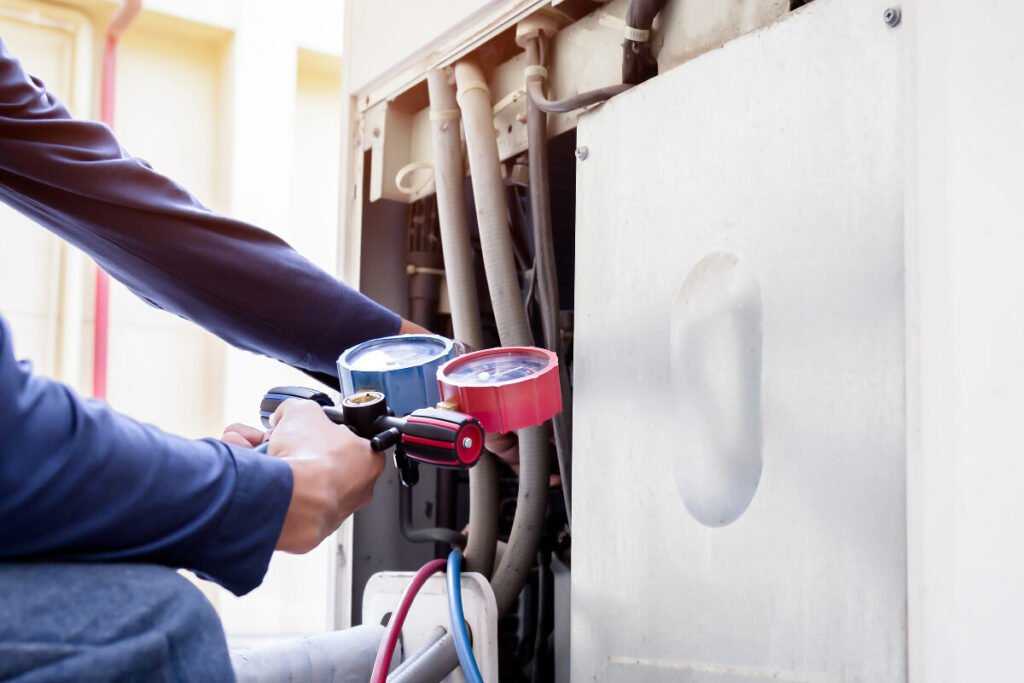 A man is working on an air conditioning unit.