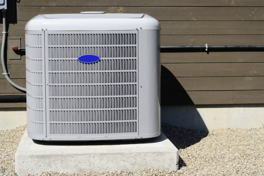An energy-efficient HVAC system, including an air conditioner, positioned in front of a house.