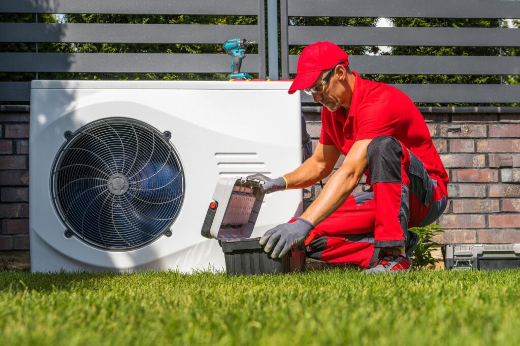 A man working on an energy-efficient air conditioning unit.