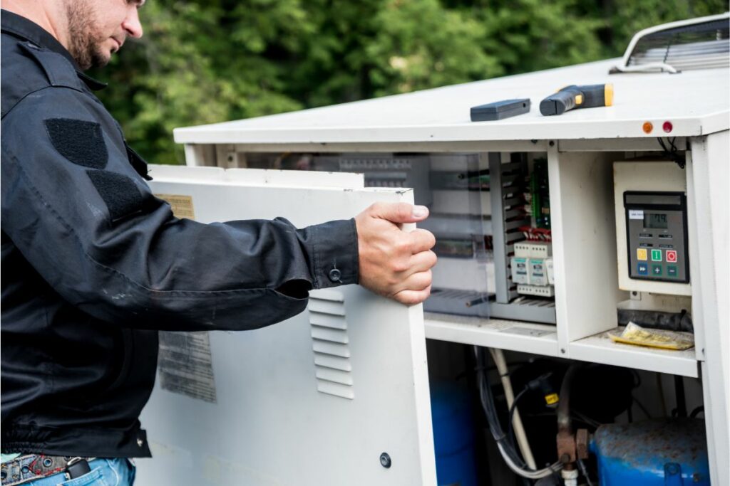 A technician adjusting controls after performing an HVAC system analysis.