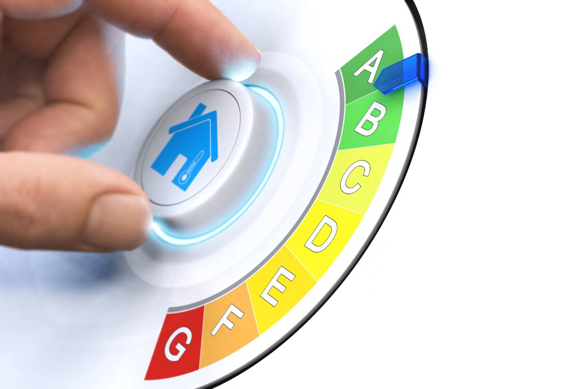 A hand turning a knob with a blue house icon, adjusting an efficiency rating scale from G to A, highlighting HVAC energy solutions with a blue indicator pointing to A.