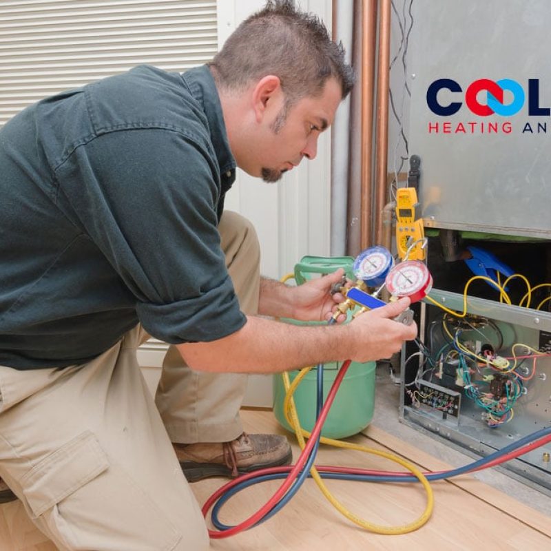 A man is working on an air conditioning unit.