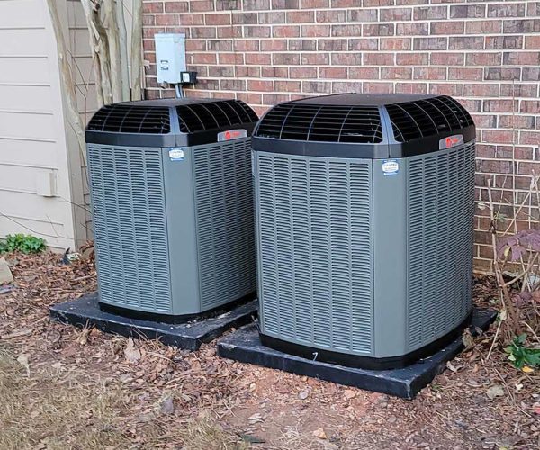 Air conditioning services provided for two units located in front of a brick wall. AC repair services are provided for two units on ac maintenance plans located behind a building.