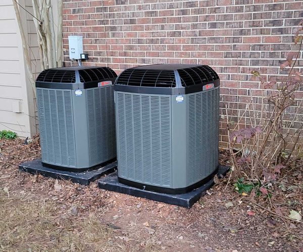 Discount air conditioners in front of a house. Discount air conditioners in front of a house because of affordable ac tune-ups.