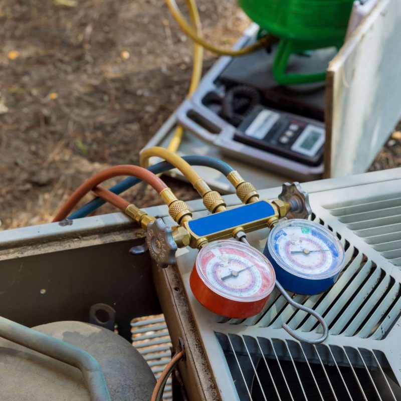 A commercial air conditioning unit with an attached gauge.