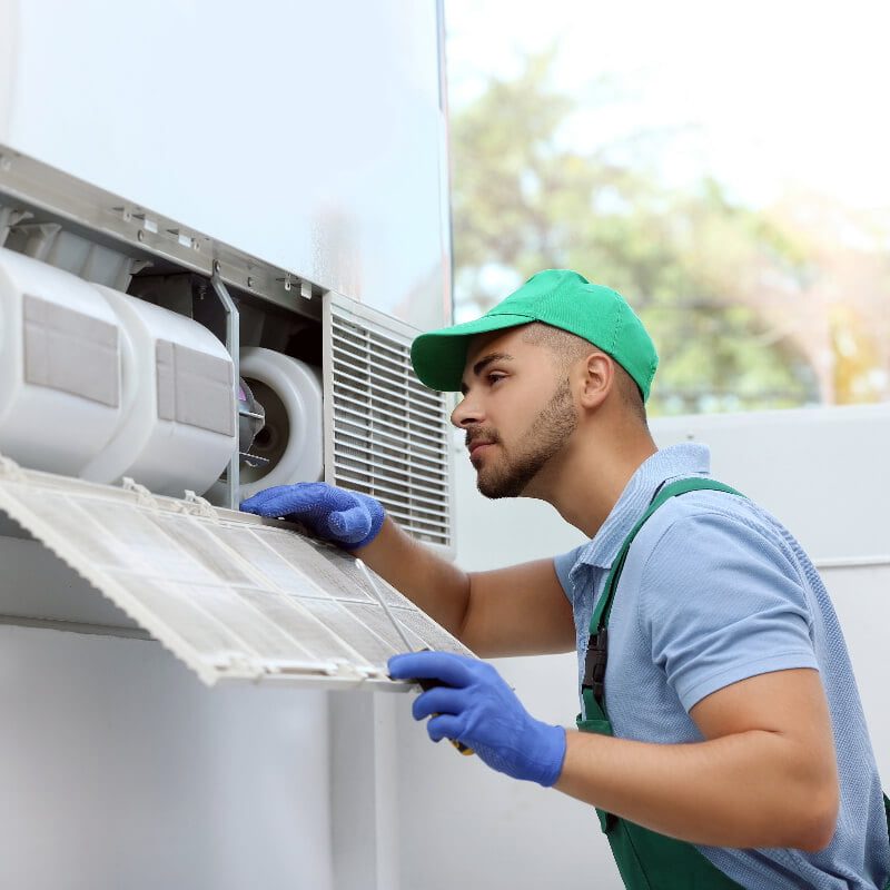 A Coolpro technician providing commercial hvac replacement services for an hvac unit.